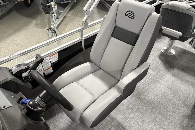 Slide: The Image of 2026 Sun Tracker SportFish 22 DLX boat seat with steering wheel, gray upholstery. - 24