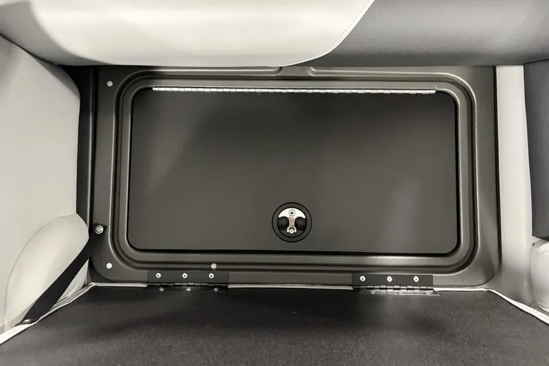 Slide: The Image of 2026 Sun Tracker SportFish 22 DLX storage compartment with secure latch. - 26