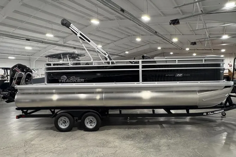 Slide: The Image of 2026 Sun Tracker SportFish 22 DLX pontoon boat in a showroom, side view. - 41