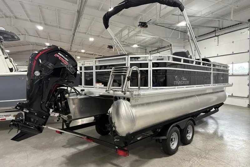 Slide: The Image of 2026 Sun Tracker SportFish 22 DLX pontoon boat with Mercury engine in a showroom. - 6