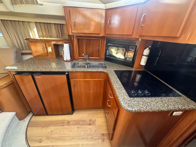 Slide: The Image of Interior of 2004 Carver 396 Motor Yacht featuring kitchen. - 15