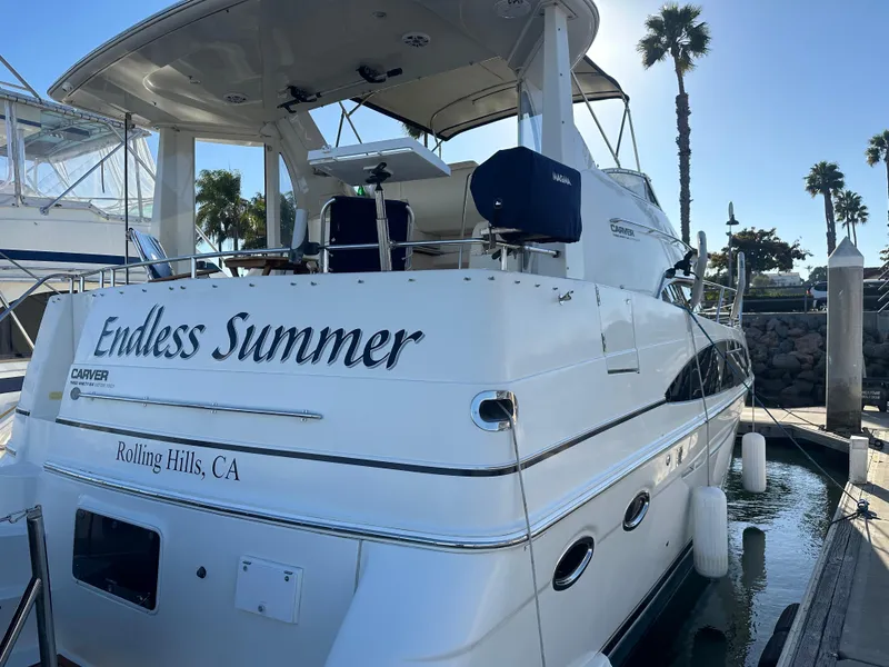 Slide: The Image of 2004 Carver 396 Motor Yacht docked, featuring "Endless Summer" lettering. - 3