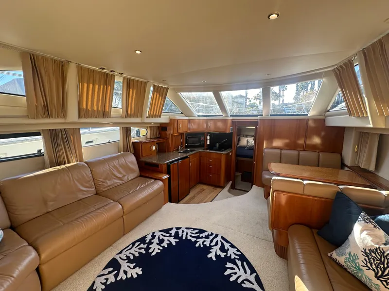 Slide: The Image of Interior of 2004 Carver 396 Motor Yacht with leather sofas and wooden furnishings. - 10