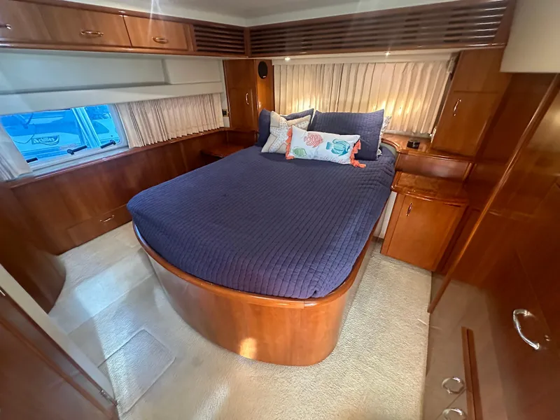 Slide: The Image of Luxurious bedroom in 2004 Carver 396 Motor Yacht with nautical-themed bedding. - 19