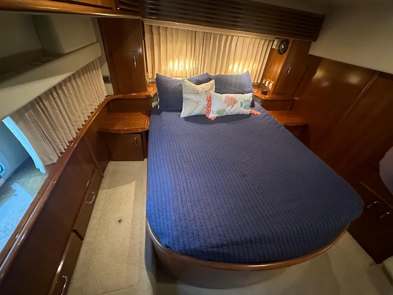 Slide: The Image of Cozy bedroom in 2004 Carver 396 Motor Yacht with nautical-themed bedding. - 22