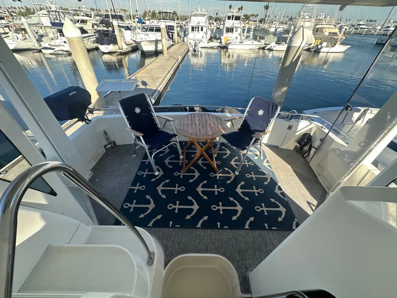 Slide: The Image of 2004 Carver 396 Motor Yacht with harbor view and seating area. - 6