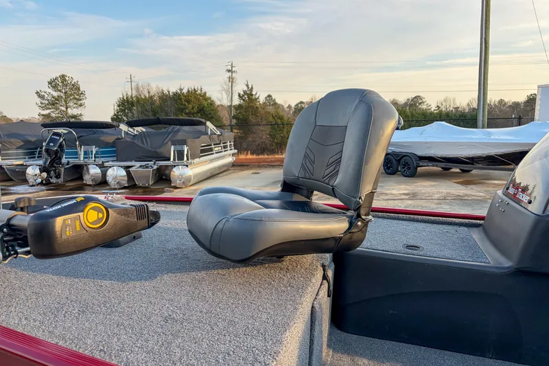 Slide: The Image of 2020 Tracker Bass Tracker Classic XL boat seat and control panel in a marina setting. - 5