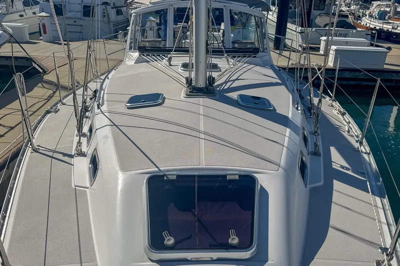 Slide: The Image of Deck view of a 2022 Catalina 385 sailboat, showcasing rigging and hatches. - 14