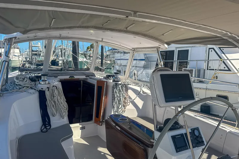 Slide: The Image of Cockpit of 2022 Catalina 385 sailboat with Garmin navigation system and steering wheel. - 22
