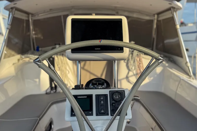 Slide: The Image of Cockpit of a 2022 Catalina 385 sailboat with steering wheel and wooden table. - 24