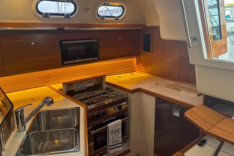 Slide: The Image of Interior of 2022 Catalina 385 yacht with cozy seating and nautical decor. - 29