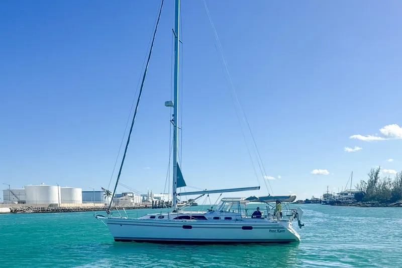 Slide: The Image of 2022 Catalina 385 sailboat on calm waters under clear blue sky. - 3