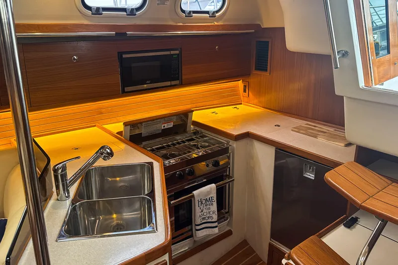 Slide: The Image of Interior of 2022 Catalina 385 yacht with cozy seating and nautical decor. - 30