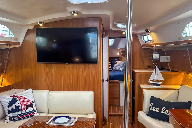 Slide: The Image of Cozy cabin interior of 2022 Catalina 385 sailboat with striped bedding and nautical decor. - 37