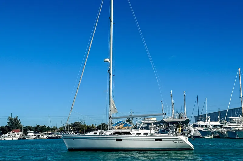 Slide: The Image of 2022 Catalina 385 sailboat docked in a marina under clear blue skies. - 4