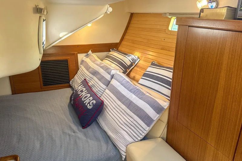 Slide: The Image of Interior of 2022 Catalina 385 sailboat bathroom with shower and storage shelves. - 46
