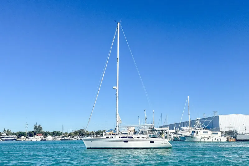 Slide: The Image of Sailboat Catalina 385, 2022 model, anchored in a marina under clear blue skies. - 5