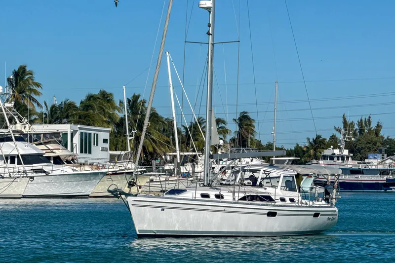 Slide: The Image of Sailboat Catalina 385, 2022 model, anchored in a marina under clear blue skies. - 6