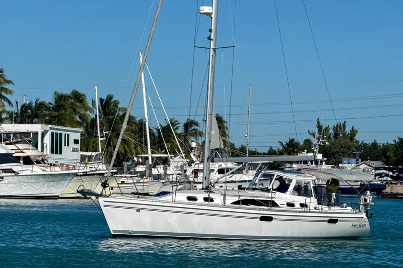 Slide: The Image of 2022 Catalina 385 sailboat docked in a marina under clear blue skies. - 7