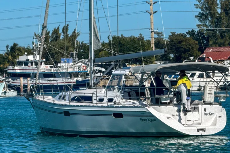 Slide: The Image of 2022 Catalina 385 sailboat docked in a marina under clear blue skies. - 9