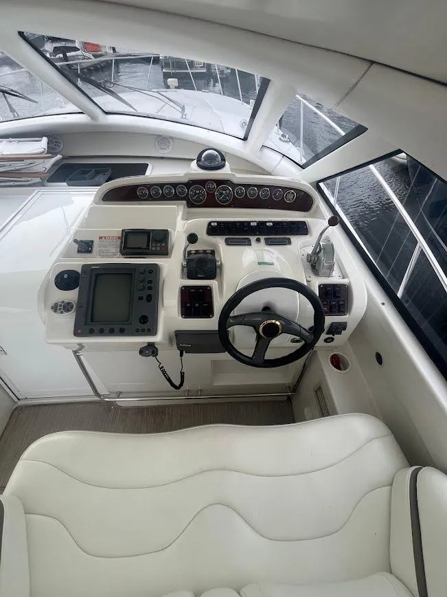 Slide: The Image of Helm of 2000 Carver 440 Hardtop Express with navigation instruments and steering wheel. - 11