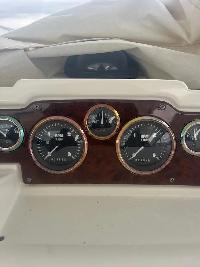 Slide: The Image of Dashboard of 2000 Carver 440 Hardtop Express with RPM gauges and instruments. - 12