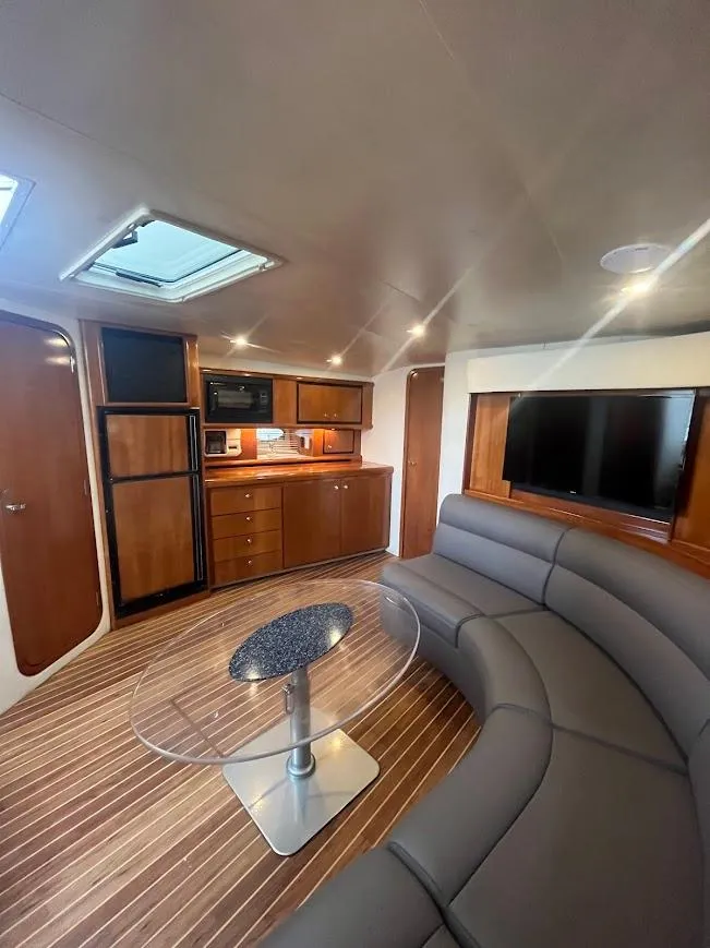 Slide: The Image of Interior of 2000 Carver 440 Hardtop Express yacht with modern furnishings and wood accents. - 15