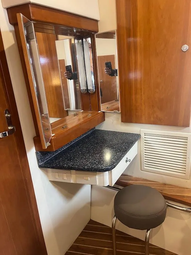 Slide: The Image of Carver 440 Hardtop Express 2000 interior with vanity, mirror, and stool. - 21