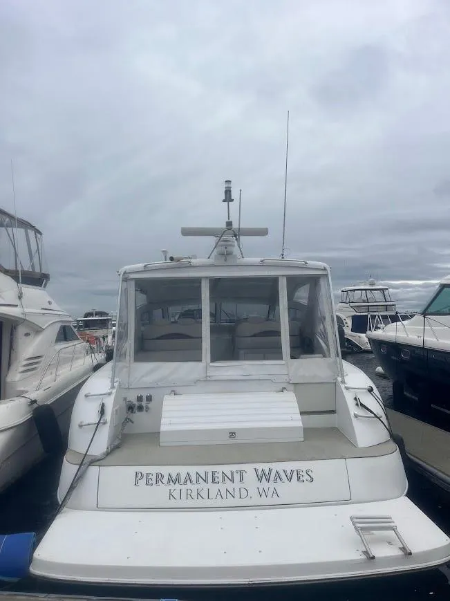 Slide: The Image of 2000 Carver 440 Hardtop Express docked, labeled "Permanent Waves," Kirkland, WA. - 4