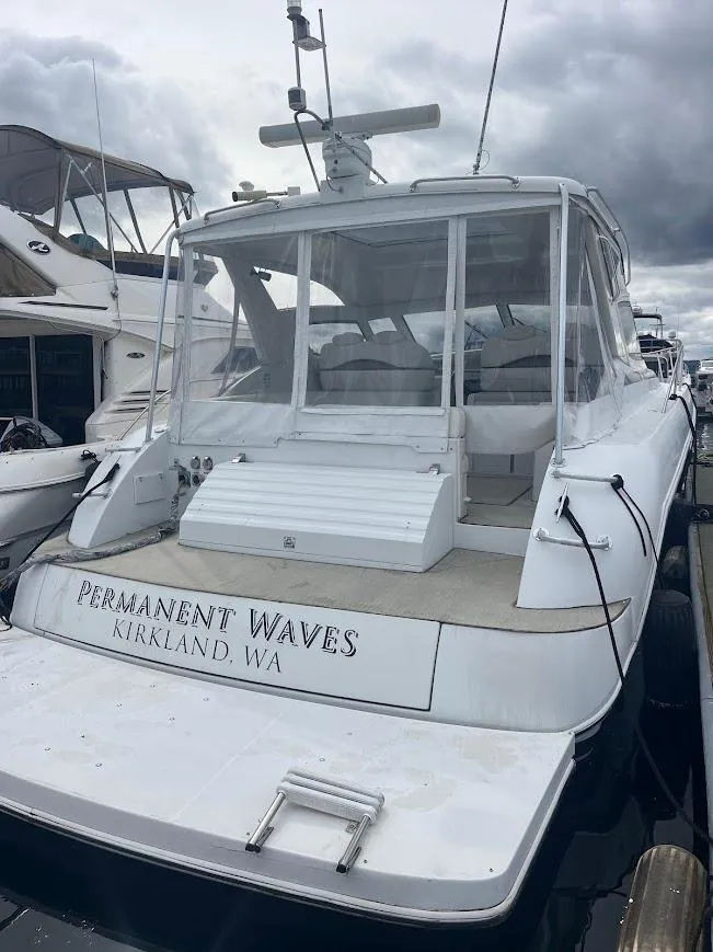 Slide: The Image of Carver 440 Hardtop Express 2000 yacht docked, named "Permanent Waves," in Kirkland, WA marina. - 6