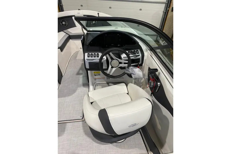 Slide: The Image of 2026 Regal 2000 ES boat interior with modern steering and white seating. - 5