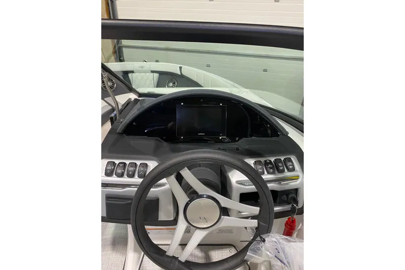 Slide: The Image of 2026 Regal 2000 ES boat dashboard with steering wheel and control panel. - 6