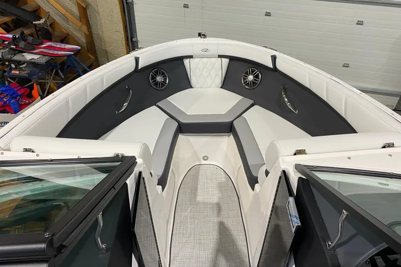 Slide: The Image of 2026 Regal 2000 ES boat interior with white and gray seating, speakers, and open windshield. - 7