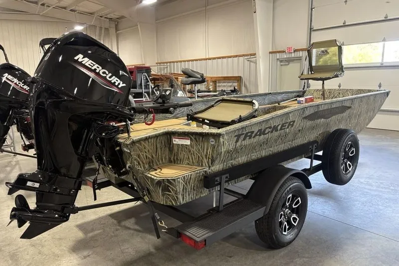 Slide: The Image of 2026 Tracker Grizzly 1650 T Prairie Wings Edition boat with Mercury engine in showroom. - 3