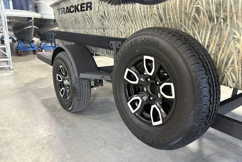 Slide: The Image of 2026 Tracker Grizzly 1650 T Prairie Wings Edition trailer with camo design and black alloy wheels. - 4