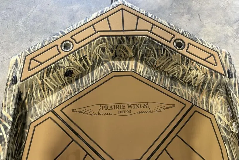 Slide: The Image of 2026 Tracker Grizzly 1650 T Prairie Wings Edition boat with camouflage design and logo. - 5