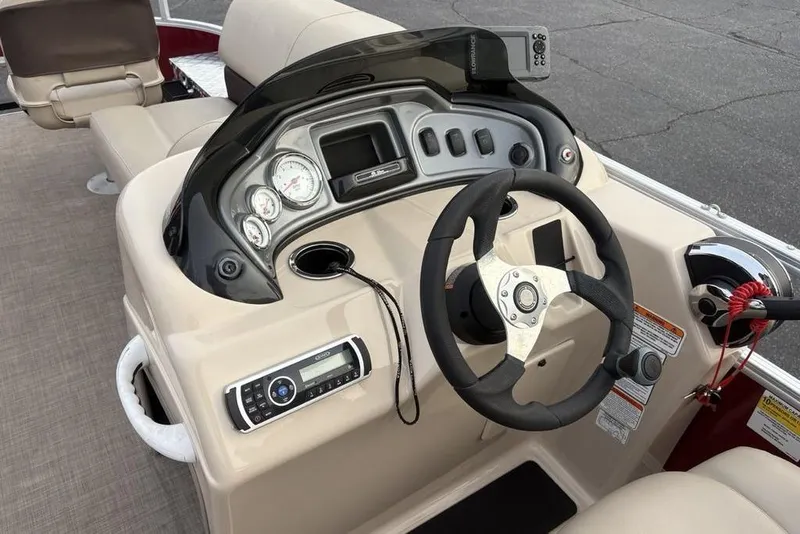 Slide: The Image of 2019 Sun Tracker Fishin' Barge 20 DLX dashboard with steering wheel and controls. - 16