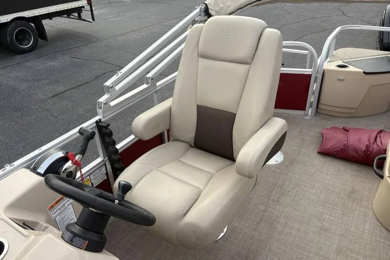 Slide: The Image of 2019 Sun Tracker Fishin' Barge 20 DLX captain's chair and steering console on deck. - 18