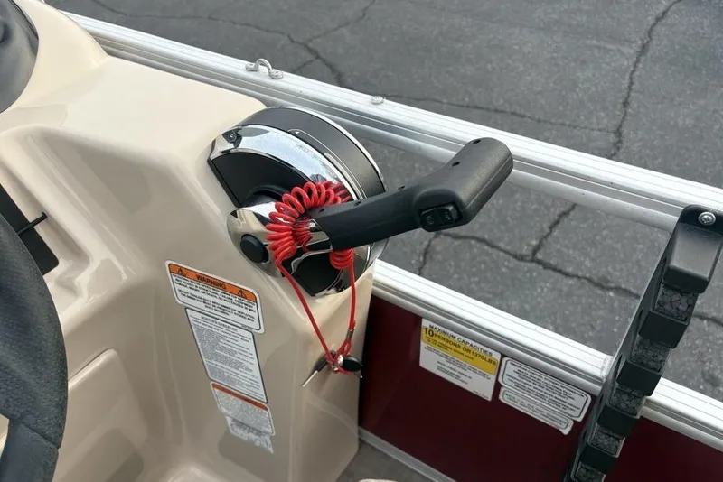Slide: The Image of 2019 Sun Tracker Fishin' Barge 20 DLX throttle control with safety lanyard on boat console. - 21