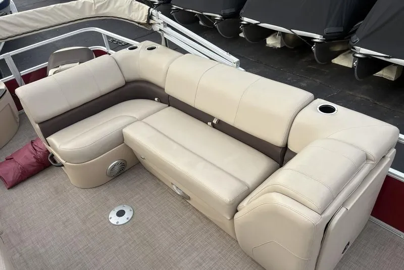 Slide: The Image of 2019 Sun Tracker Fishin' Barge 20 DLX, beige seating with cup holders and speaker. - 24