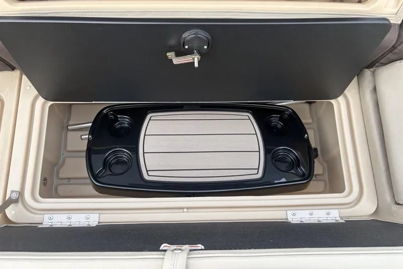 Slide: The Image of 2019 Sun Tracker Fishin' Barge 20 DLX storage compartment with cup holders and table. - 28