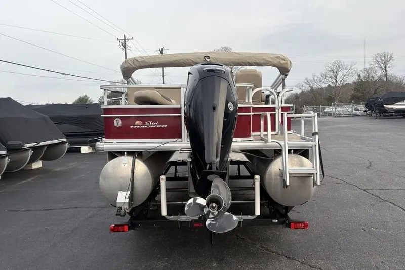 Slide: The Image of 2019 Sun Tracker Fishin' Barge 20 DLX pontoon boat, rear view with motor and ladder. - 8