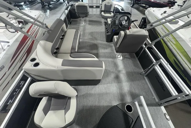 Slide: The Image of 2026 Sun Tracker Bass Buggy 18 DLX pontoon boat interior with seating and steering console. - 19