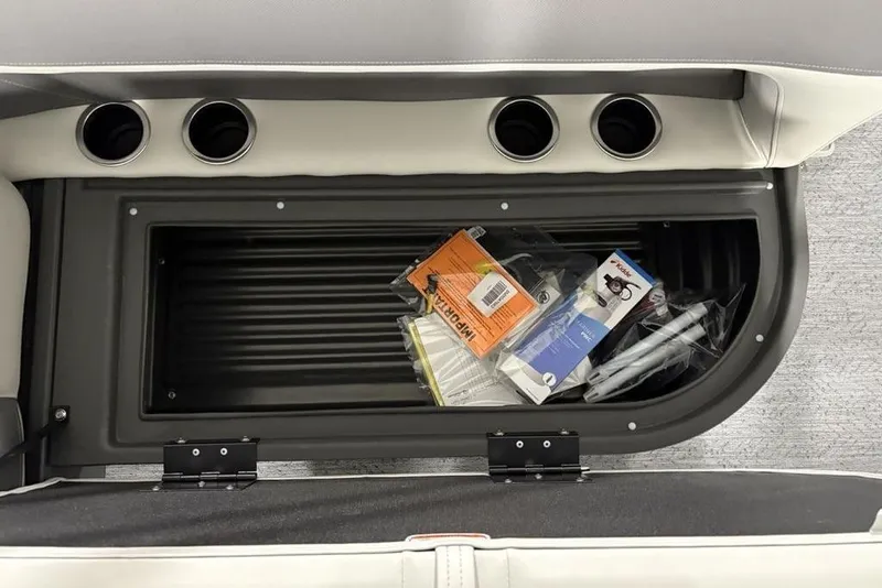 Slide: The Image of Storage compartment in 2026 Sun Tracker Bass Buggy 18 DLX, containing various boating accessories. - 23