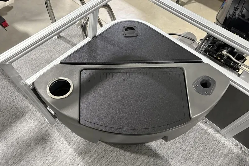 Slide: The Image of 2026 Sun Tracker Bass Buggy 18 DLX boat console with cup holder and measurement markings. - 24