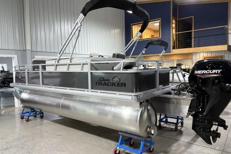 Slide: The Image of 2026 Sun Tracker Bass Buggy 18 DLX pontoon boat with Mercury engine in showroom. - 4