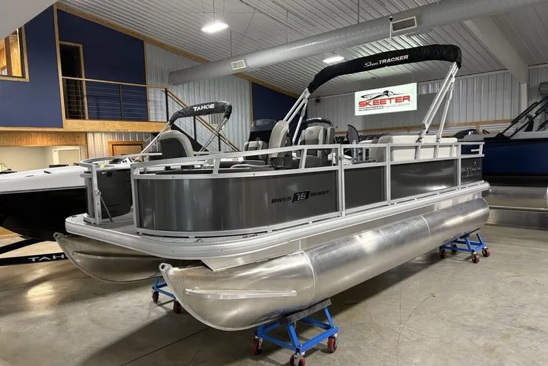 Slide: The Image of 2026 Sun Tracker Bass Buggy 18 DLX pontoon boat in showroom setting. - 5