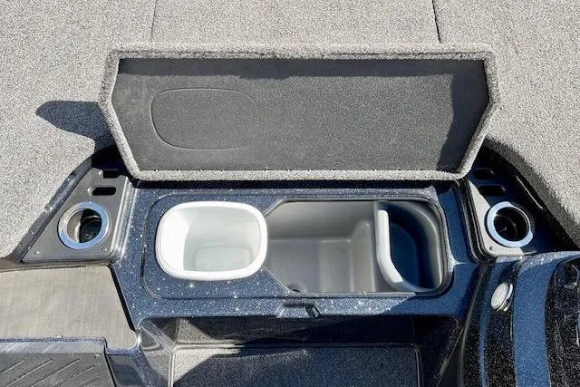 Slide: The Image of 2024 Nitro Z20 Pro boat storage compartment with cup holders and open lid. - 19