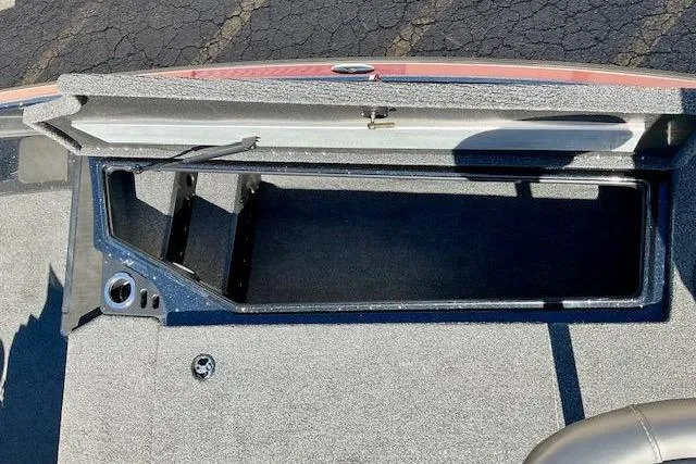 Slide: The Image of Open storage compartment on 2024 Nitro Z20 Pro boat, featuring carpeted interior. - 21