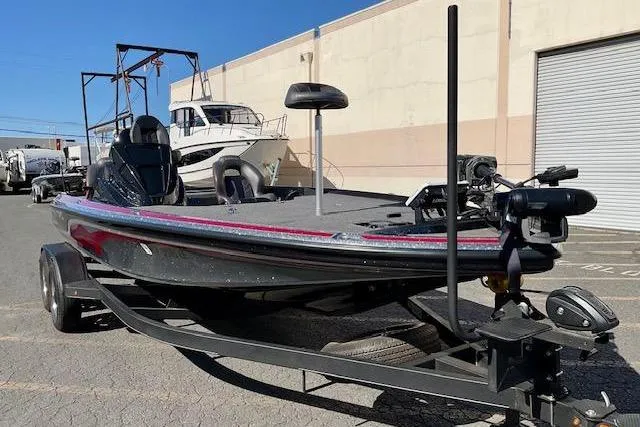 Slide: The Image of 2024 Nitro Z20 Pro bass boat on trailer, parked outdoors near a warehouse. - 7